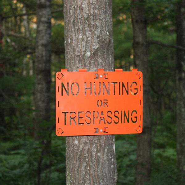 Molded Forever Sign Orange No Hunting or Trespassing installed on a tree