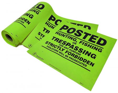 posted no trespassing sign on a roll lime green